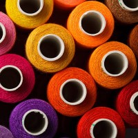 Sewing threads multicolored background closeup